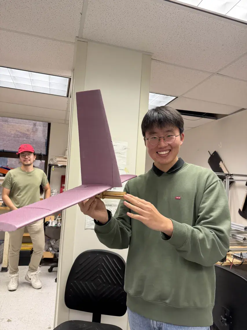 Team member holding a shaped foam tail